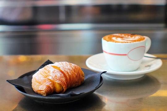 typical Italian breakfast in the cafeteria with sfogliatella and cappuccino