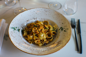 plate of calamari with paccheri with red tuna, cooked with celery, carrots, onion and Taggiasca...