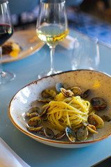 fresh bronze-drawn spaghetti and a sprinkling of parsley and Cilento oil with a glass of wine in a luxury Italian restaurant - 309278973