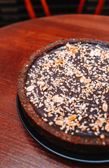 Raw vegan chocolate cake with peanuts, healthy sweets.