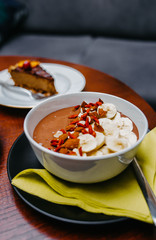 Healthy oat meal with cocoa, bananas and goji berries. 