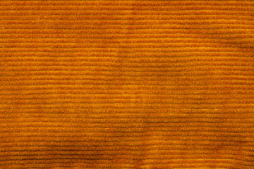 Texture of corduroy velvet fabric close-up. Texture of rufous velvet clothes. Textile fabric as...