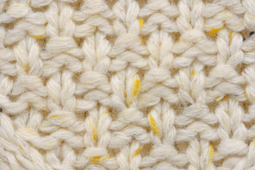 The texture of a knitted sweater. Beige pattern. Inside. Background. Copy space