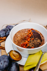 Healthy vegan oatmeal with goji and cocoa.