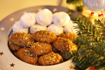 greek melomakarona and kourabies - traditional Christmas cookies with honey and nuts and sugar buns - night home Christmas scene