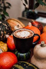 Cup of pumpkin latte with seasonal autumn spices.