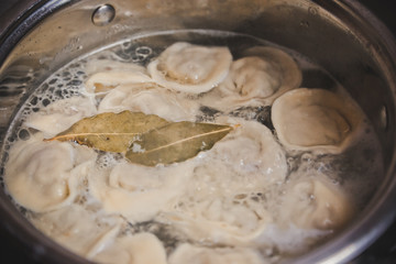 pan with boiled dumplings and a leaf of parsley