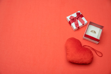 box with a ring and a heart on a red background. concept of the holiday, Valentine's day