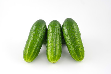 Green cucumbers close-up on a white background