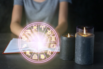 Fototapeta premium Burning candles on table of female astrologist