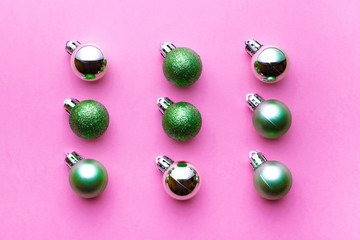 Xmas background. Christmas decoration balls isolated on pink. Abstract winter concept. Flat lay