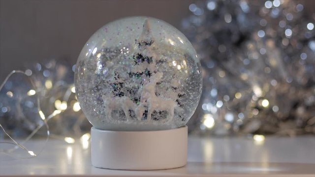 Crystal ball with Christmas themes and artificial snow 