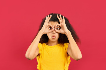 Surprised African-American woman on color background