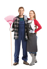 Couple with rake for autumn leaves clean-up on white background