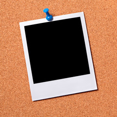 Blank photo pinned to a cork board