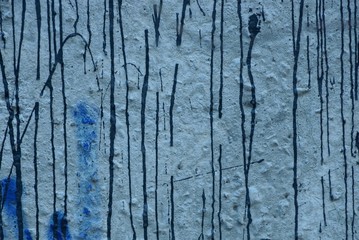 color texture with spots of paint on a dirty concrete wall