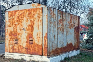 one gray brown metal container in rust stands on the street