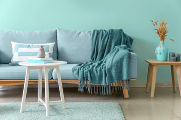 Fototapeta na wymiar Stylish interior of living room in turquoise color