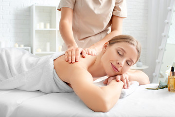 Obraz na płótnie Canvas Beautiful woman receiving massage in spa salon