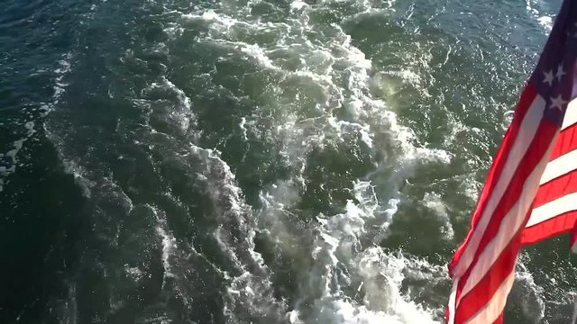 Boat wake with American flag