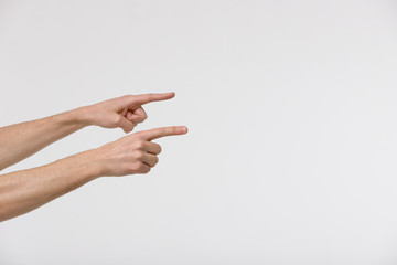 Close up of male hands point with index fingers to empty space or culprit, isolated on white background. 