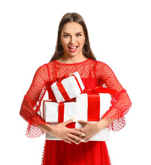 Beautiful young woman with Christmas gifts on white background