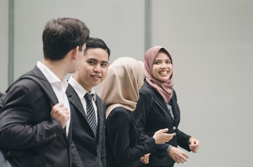 happy expression face group of young executive people in formalwear standing over shallow depth of field background