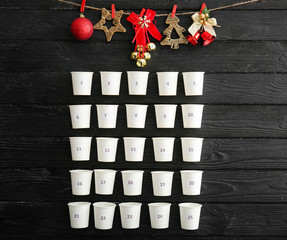 Christmas advent calendar on dark wooden background