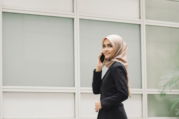 Portrait of young Office Woman Talking to Someone on her Mobile Phone with Happy Facial Expression.