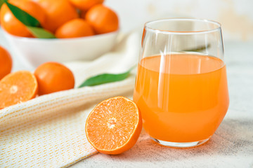 Glass of sweet tangerine juice on table