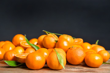 Sweet tangerines on wooden background