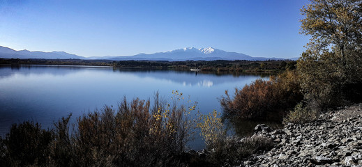 Mountain reflected in a lake. Lake of Villeneuve de la Raho (France) overlooking the Pyrenees and the Canigó.