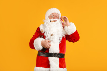 Fototapeta na wymiar Funny drunk Santa Claus with cigar on color background