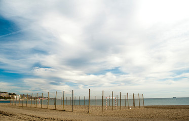 Obraz premium beautiful photo of malaga city beach, with soccer field in the sand, with wooden fence protection and ropes