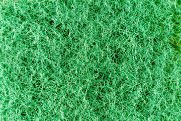 Light green sponge made of fibrous material. Texture, background. In Increase