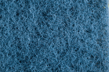 Blue sponge made of fibrous material. Texture, background. In Increase