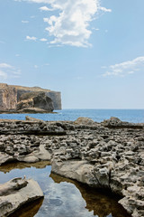 Fototapeta na wymiar blue seascape with cliff at limestone coastline in malta 