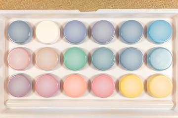 A new box with multi-colored paints for painting on the back. For the whole photo