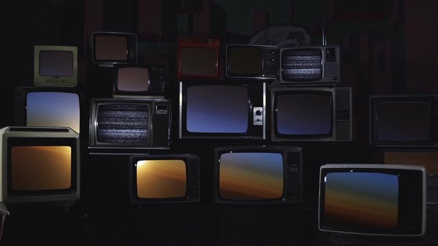 Sunset over the Planet Earth as Seen from Space, on Many 80s TVs. Blue Dark Tone. Elements of this Video furnished by NASA. 