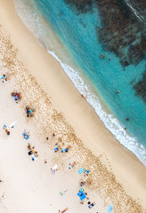 Fototapeta na wymiar Aerial drone landscape of Waikiki beach, Honolulu, Oahu, Hawaii. Ocean and peoples at famous paradise beach shot from above.