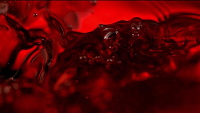 Super Slow Motion Macro Abstract Shot of Swirling Red Wine in Glass at 1000fps.
