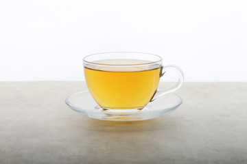 Green Tea Cup - Herbal tea anise ginger and lemon on a white texture background - white table