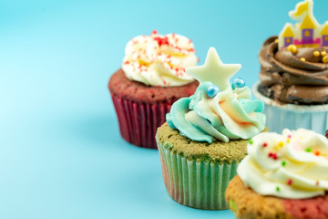 Many sweet colored cupcakes for birthdays, Merry Christmas and New Year 2020 on a blue background.