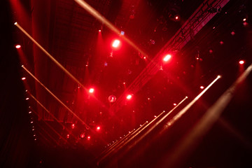 Performance moving lighting luminous rays on construction rack light beam ray downward in white red...