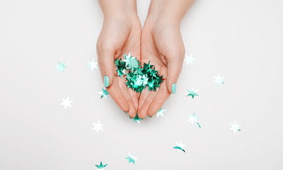 Female hand with trendy manicure in mint color. 