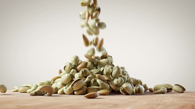 Mixed Nuts Falling on Wooden Floor. Almonds, Cashews and Pistachios Forming a Pile on White Background. Healthy Diet Superfood.