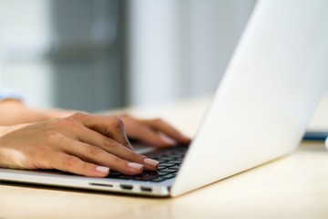 Woman hands typing on a laptop, working concept