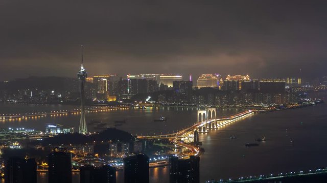 Macau Tower and bridge traffic cityscape night timelapse pan up