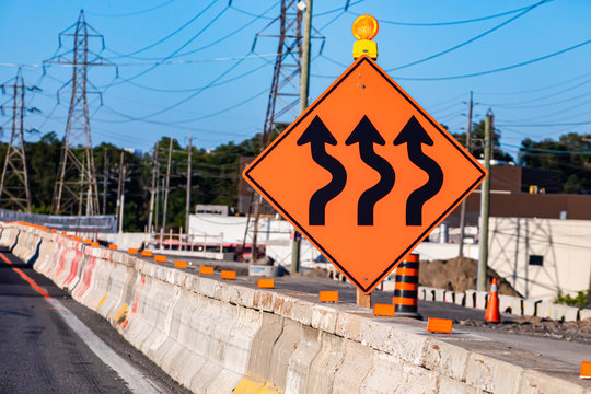 Temporary Detour From Normal Traffic Route, Three Lines Road, Temporary Condition Signs On Road Cement Barriers, Work Zone In The Background