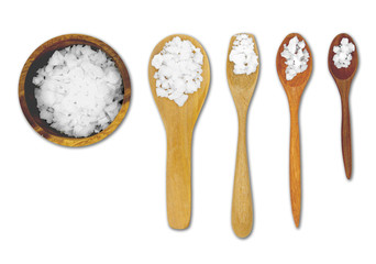 Salt scales are scooped into a spoon and then placed on a white background. The object has a cutting path.